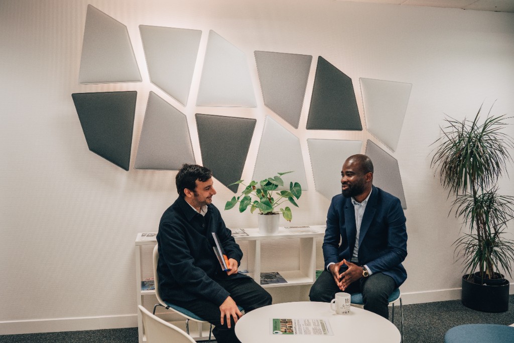 Deux collaborateurs COMEARTH en discussion dans un espace de coworking